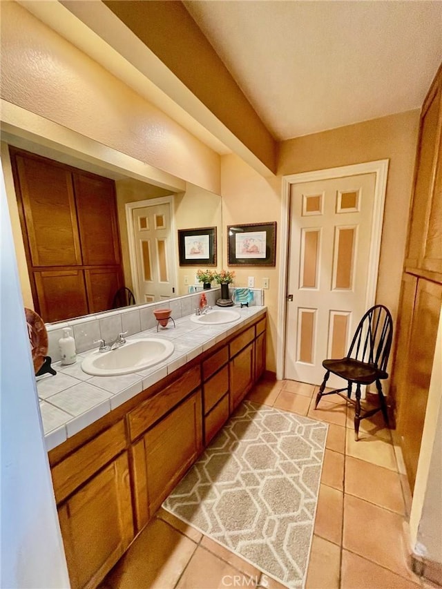 bathroom with tile patterned flooring and vanity