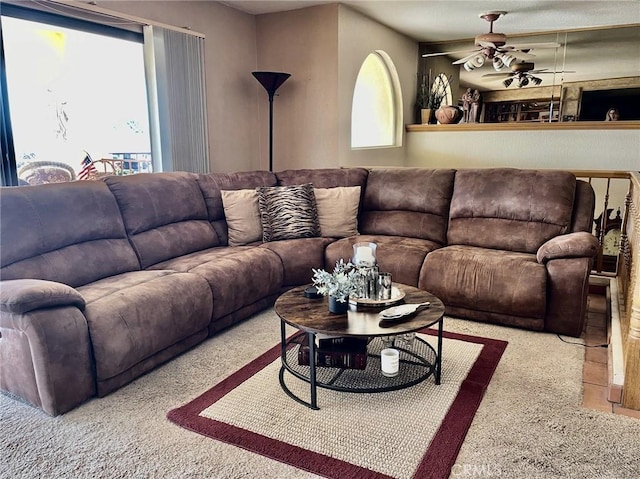 living room featuring a healthy amount of sunlight and ceiling fan