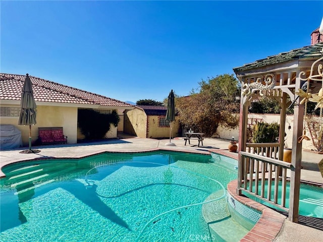 view of swimming pool featuring a patio area