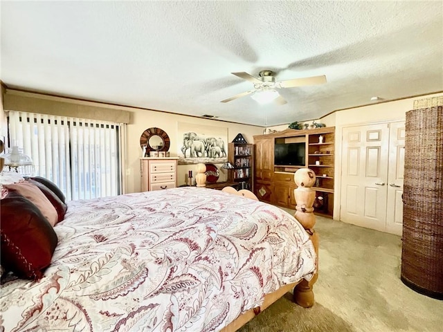 carpeted bedroom with ceiling fan and a textured ceiling