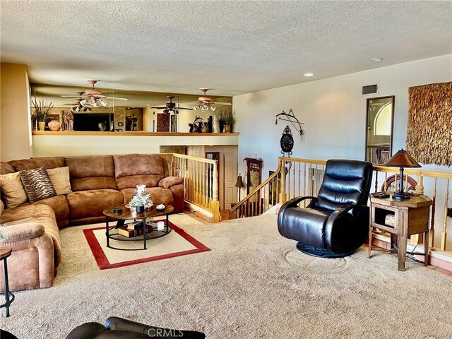 living room featuring carpet and a textured ceiling