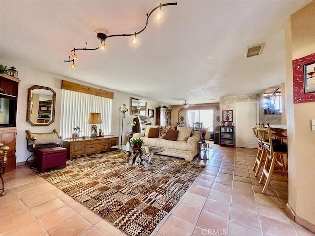 tiled living room with ceiling fan