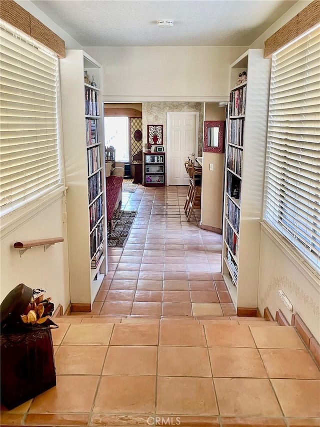 hall featuring light tile patterned floors