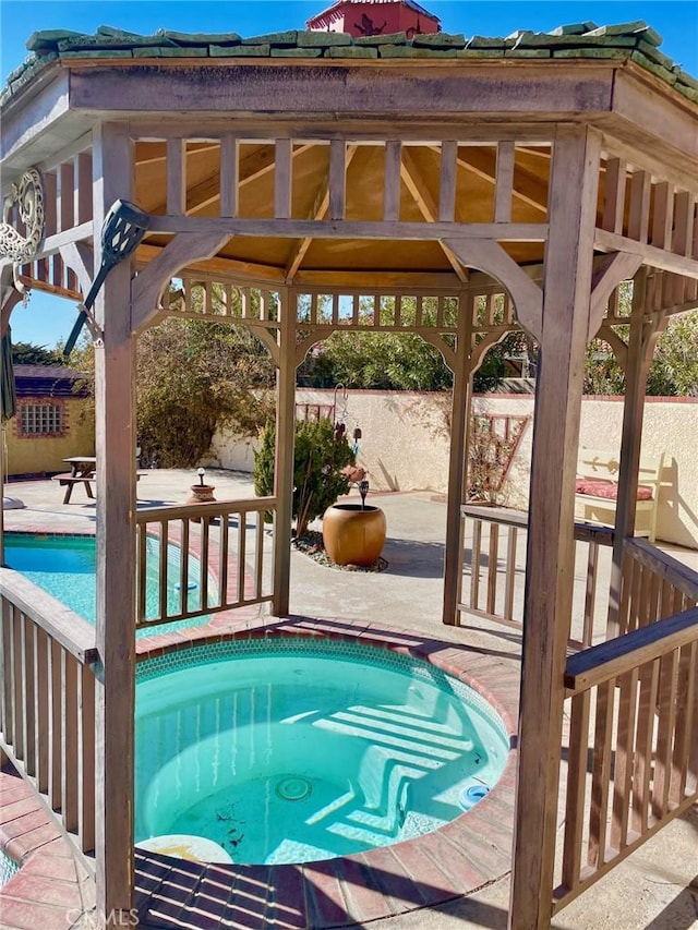 view of swimming pool with a gazebo, a patio area, and a hot tub