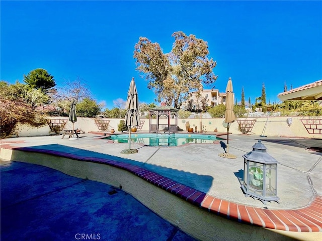 view of swimming pool featuring a gazebo and a patio area