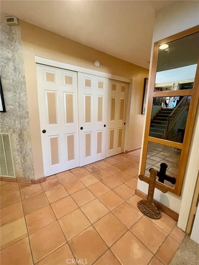 hallway featuring light tile patterned floors