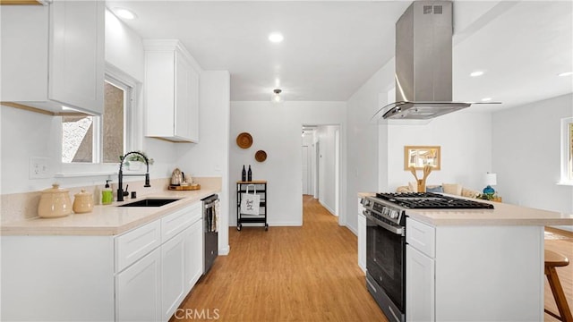 kitchen featuring sink, a breakfast bar area, white cabinetry, island exhaust hood, and stainless steel appliances