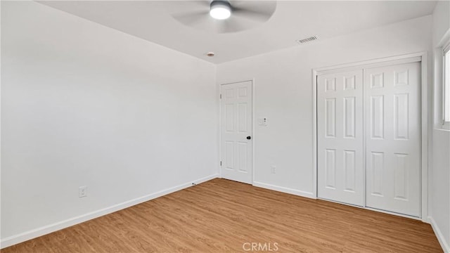 unfurnished bedroom featuring a closet, ceiling fan, and light hardwood / wood-style flooring