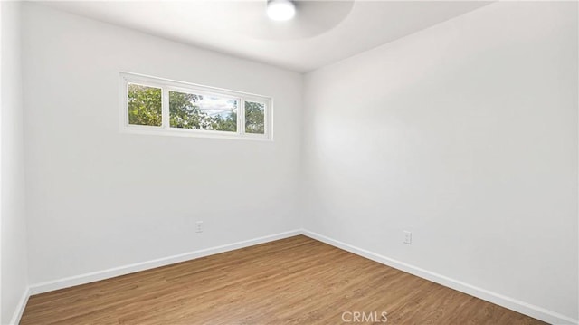 spare room with wood-type flooring