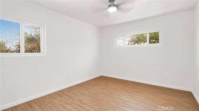 spare room with hardwood / wood-style flooring and ceiling fan