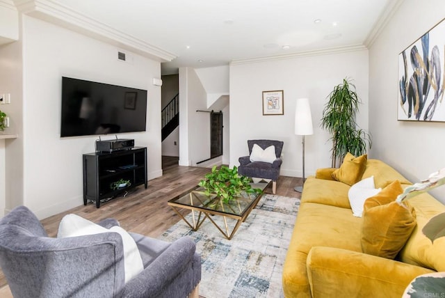 living room with hardwood / wood-style floors and crown molding