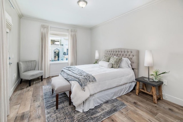 bedroom featuring ornamental molding and light wood-type flooring