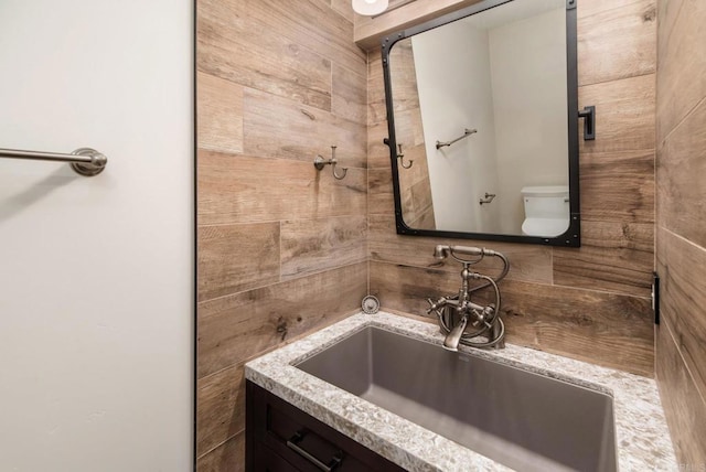 bathroom featuring vanity and toilet