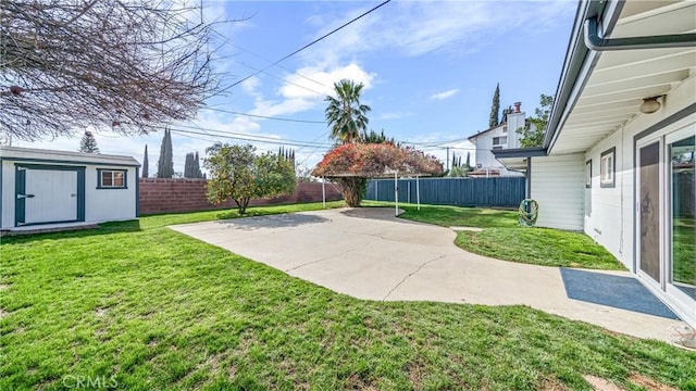 view of yard with a shed and a patio area