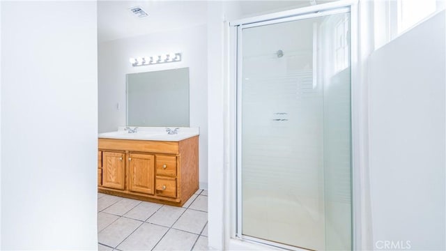 bathroom with vanity, tile patterned floors, and walk in shower