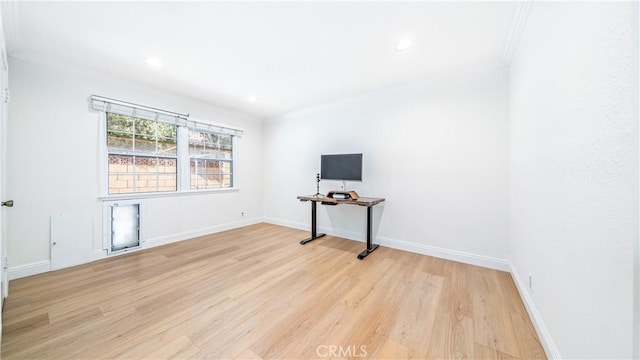 unfurnished room with ornamental molding and light wood-type flooring