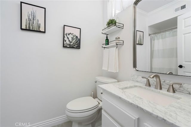 bathroom with crown molding, vanity, and toilet