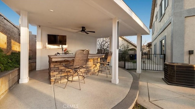 view of patio with an outdoor bar, ceiling fan, and cooling unit