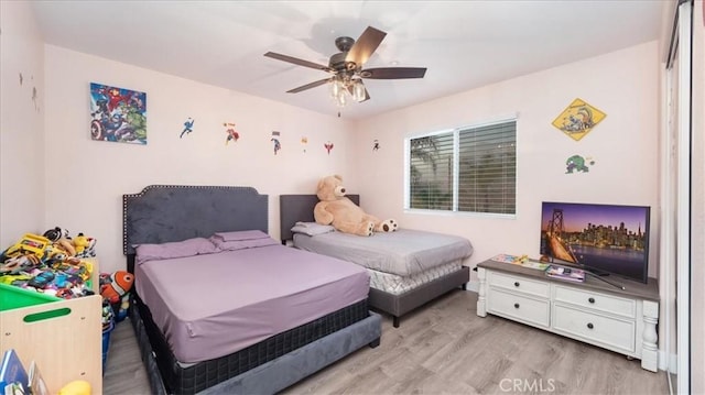 bedroom with ceiling fan and light hardwood / wood-style flooring