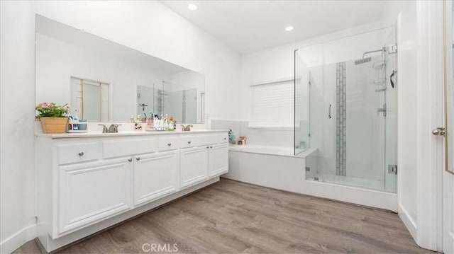 bathroom with vanity, hardwood / wood-style flooring, and shower with separate bathtub