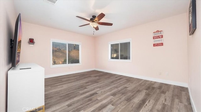 empty room with wood-type flooring and ceiling fan