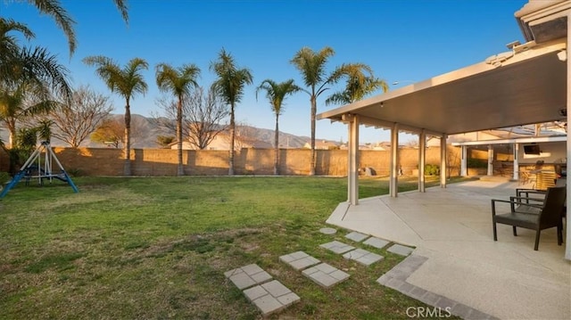 view of yard featuring a mountain view and a patio area