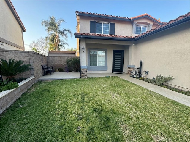 exterior space featuring a patio area and a lawn