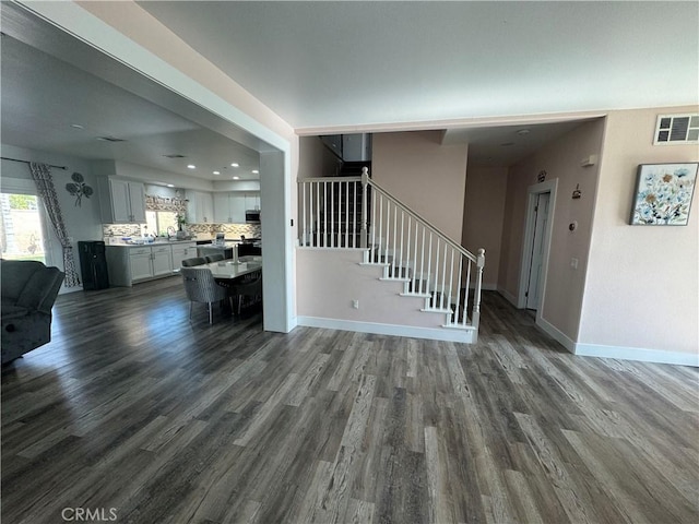 unfurnished living room featuring dark hardwood / wood-style floors