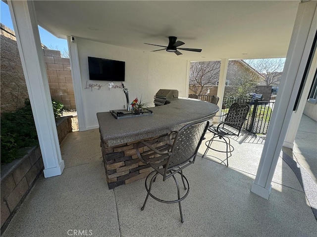 view of patio with ceiling fan and exterior bar