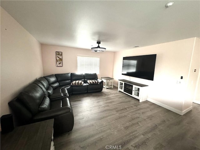 living room with baseboards and wood finished floors