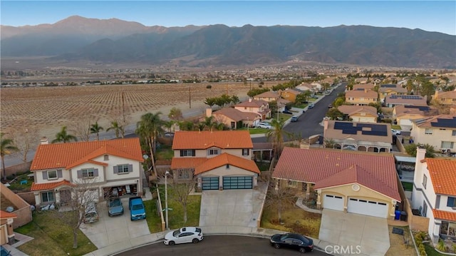 drone / aerial view featuring a residential view and a mountain view