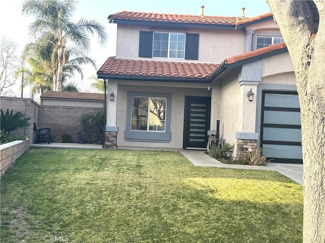 exterior space with stone siding, a front yard, fence, and stucco siding