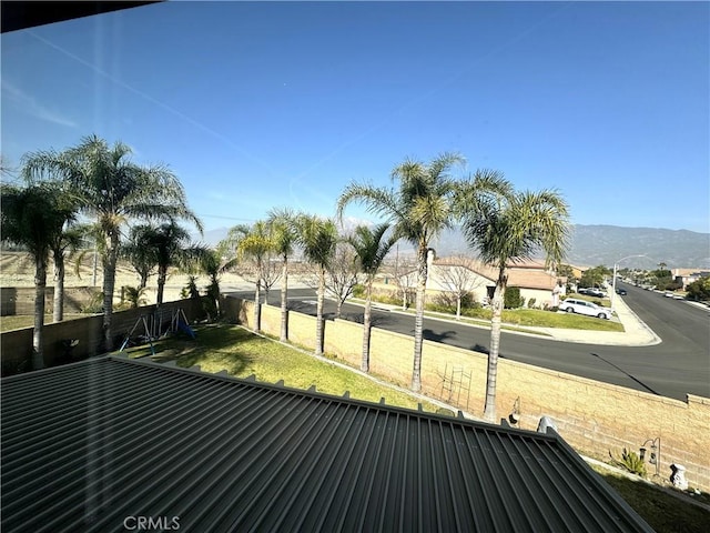 view of property's community with fence and a mountain view