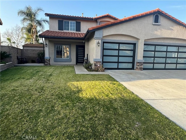 mediterranean / spanish-style house featuring an attached garage, fence, concrete driveway, stucco siding, and a front yard