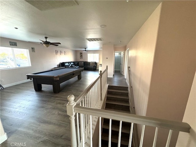 playroom featuring baseboards, visible vents, and dark wood finished floors