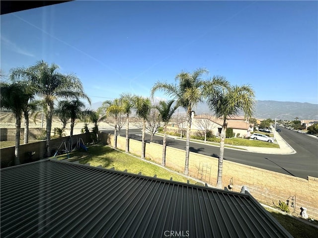 view of community with a mountain view and fence