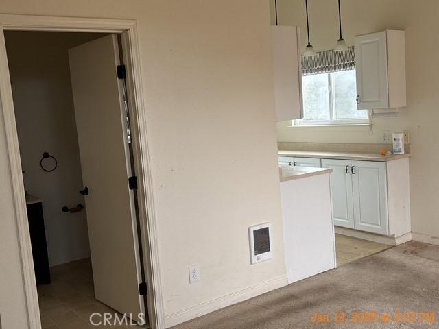 kitchen featuring pendant lighting and white cabinets