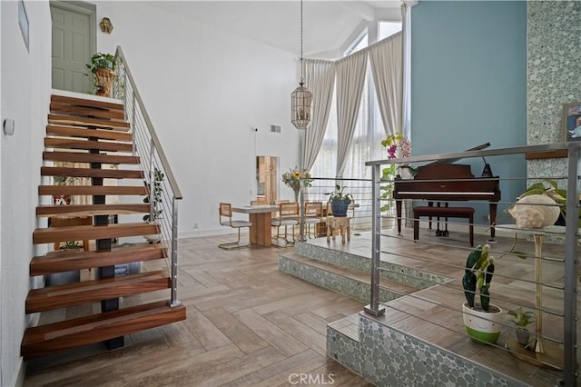 interior space featuring parquet floors and high vaulted ceiling