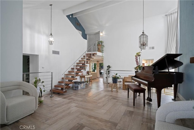 interior space featuring parquet floors, beam ceiling, and high vaulted ceiling