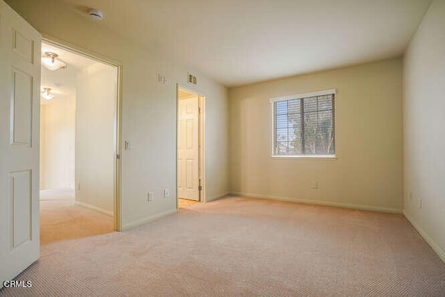 empty room featuring light colored carpet