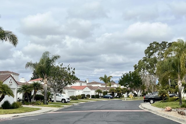 view of street with a residential view and curbs