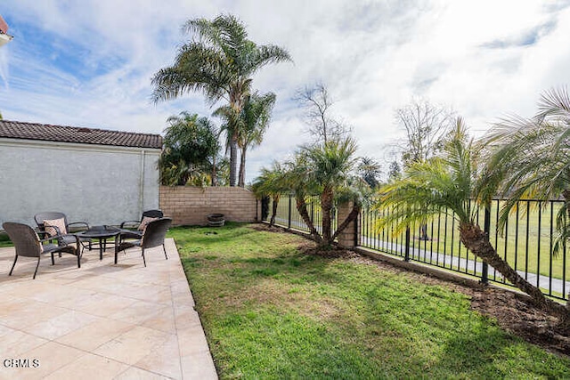 view of yard with a patio area, an outdoor fire pit, and a fenced backyard