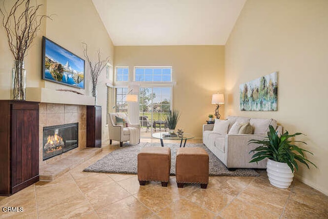 living area featuring a high ceiling and a fireplace