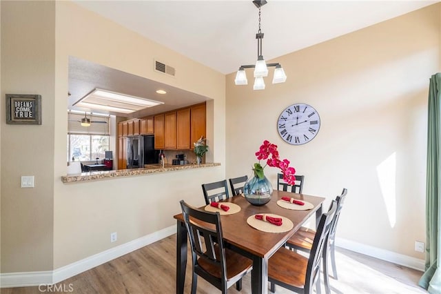 dining space featuring light wood-type flooring