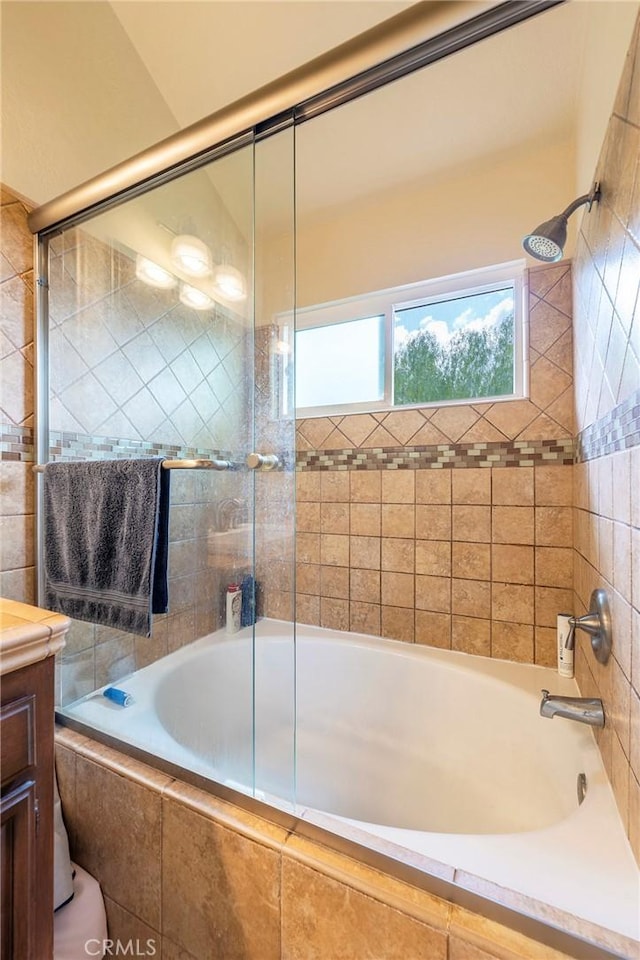 bathroom with vanity and shower / bath combination with glass door