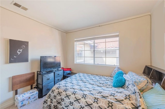 carpeted bedroom with visible vents and baseboards