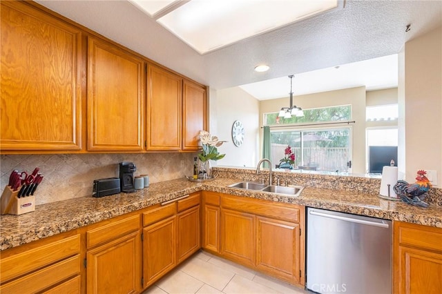 kitchen featuring light tile patterned flooring, sink, backsplash, stainless steel dishwasher, and light stone countertops