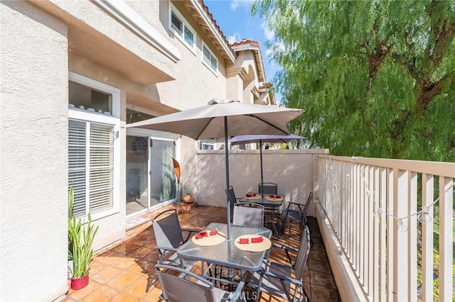 view of patio / terrace with outdoor dining area and fence