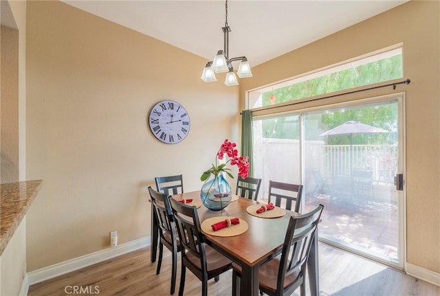 dining room featuring hardwood / wood-style floors and a chandelier