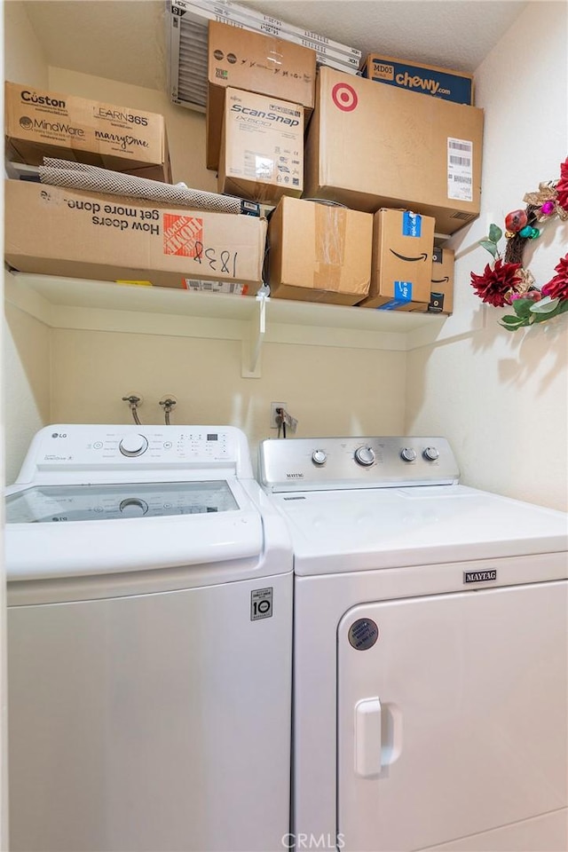 washroom featuring laundry area and washer and clothes dryer